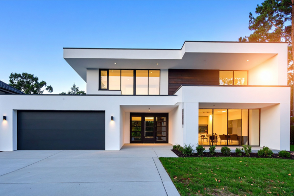 Modern two-story home with sleek design, large windows, and clean white exterior.