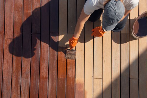 man staining a deck